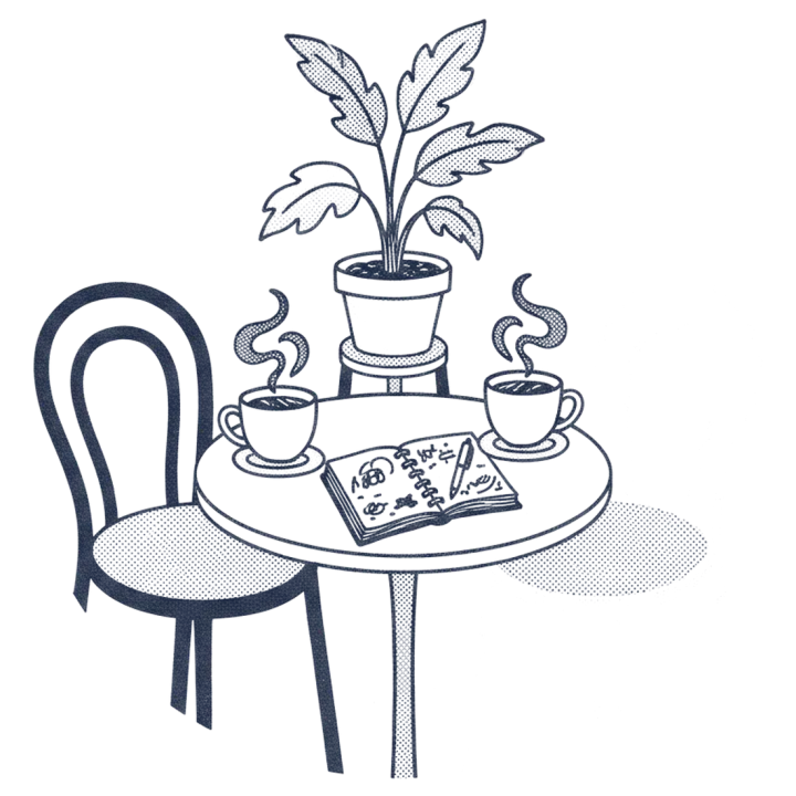 Two coffee mugs and an open notebook on a small table