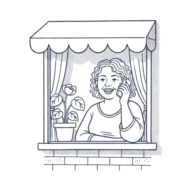 A woman smiling as she talks on the phone at her front window