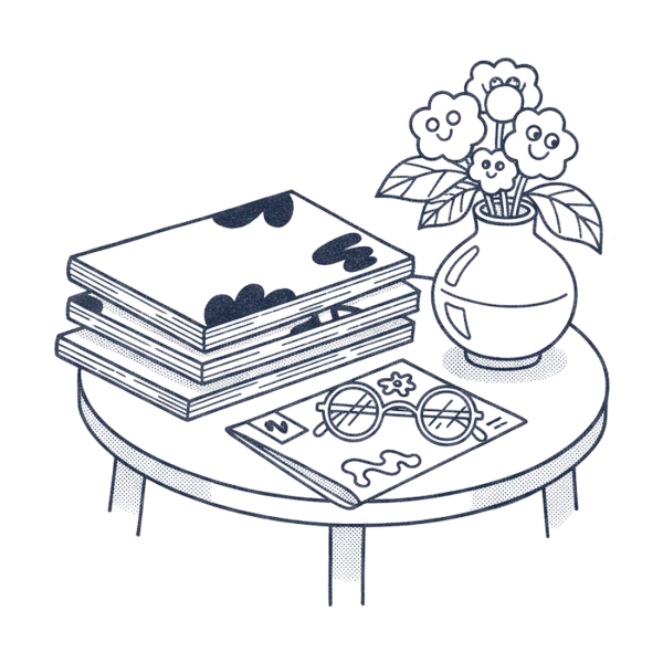 A stack of member magazines beside reading glasses and flowers
